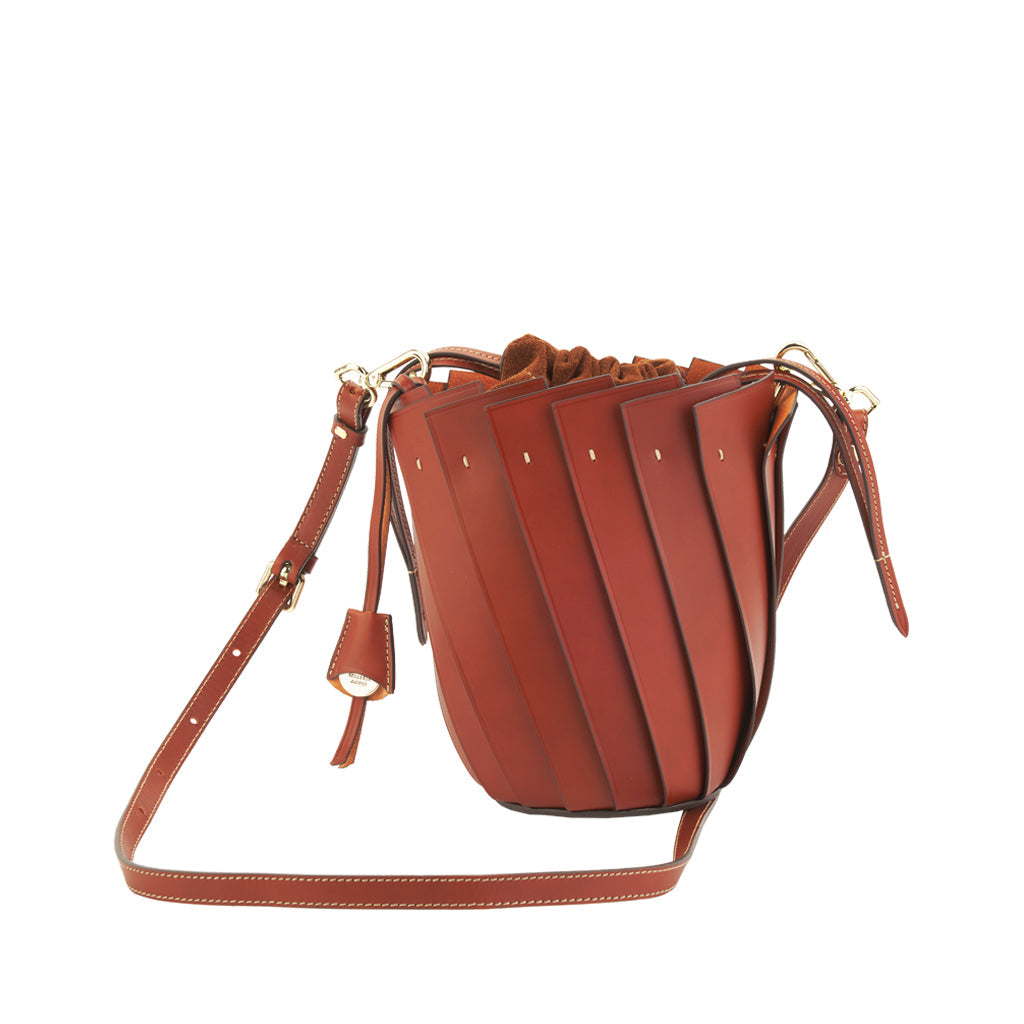 Brown leather bucket bag with adjustable strap and drawstring closure