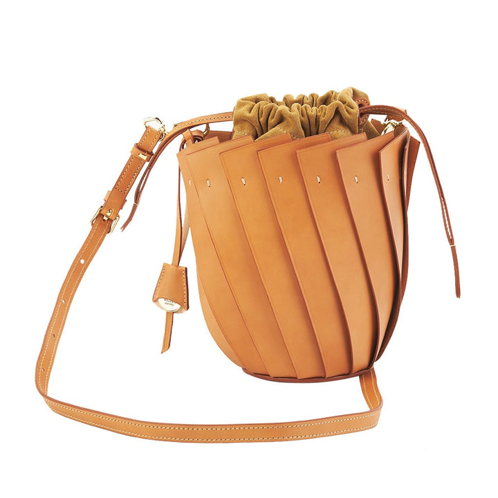 Brown leather bucket bag with adjustable strap and drawstring closure