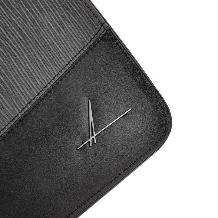 Black leather product with a unique signature logo design