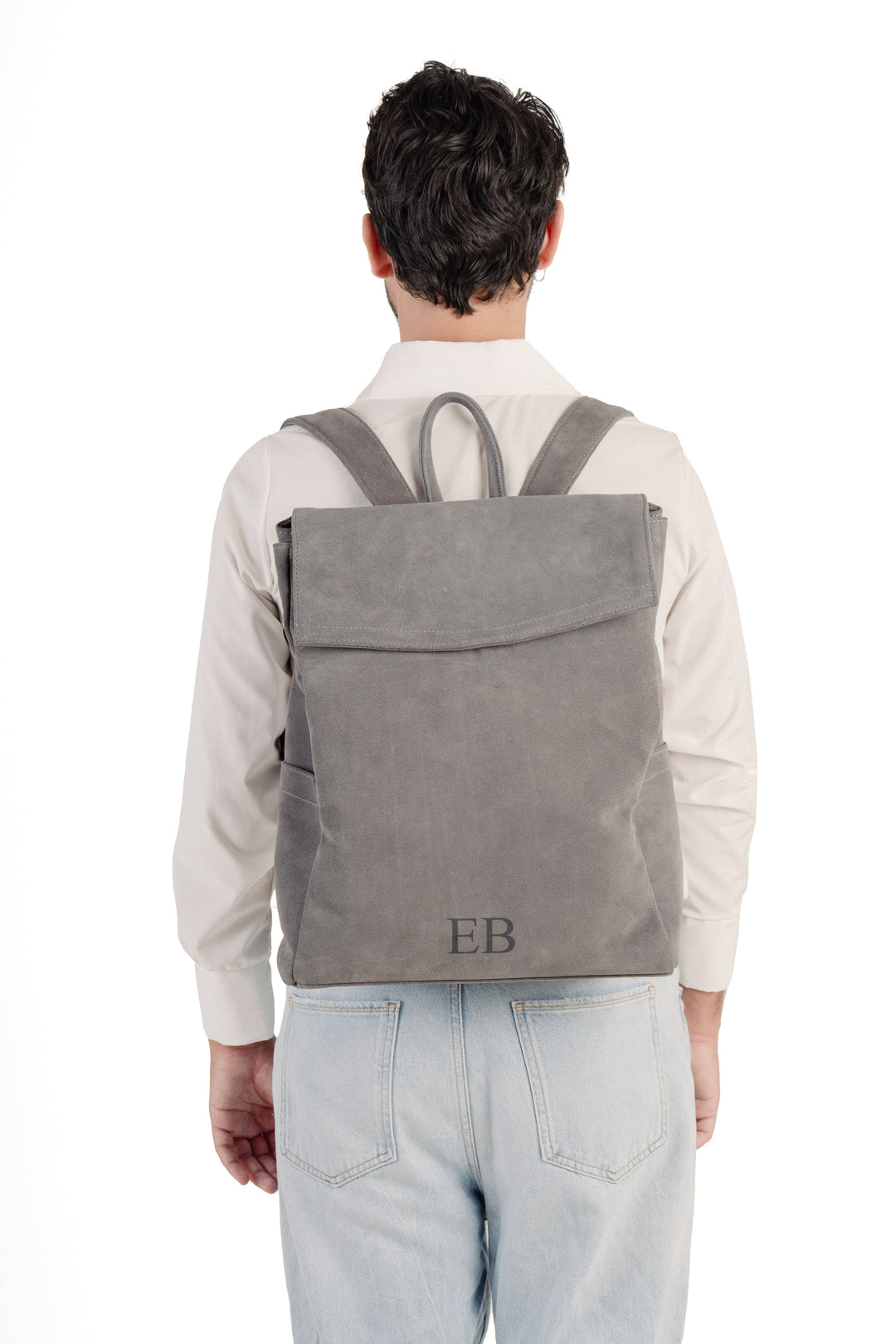 Person wearing a gray backpack with initials EB on the back pocket