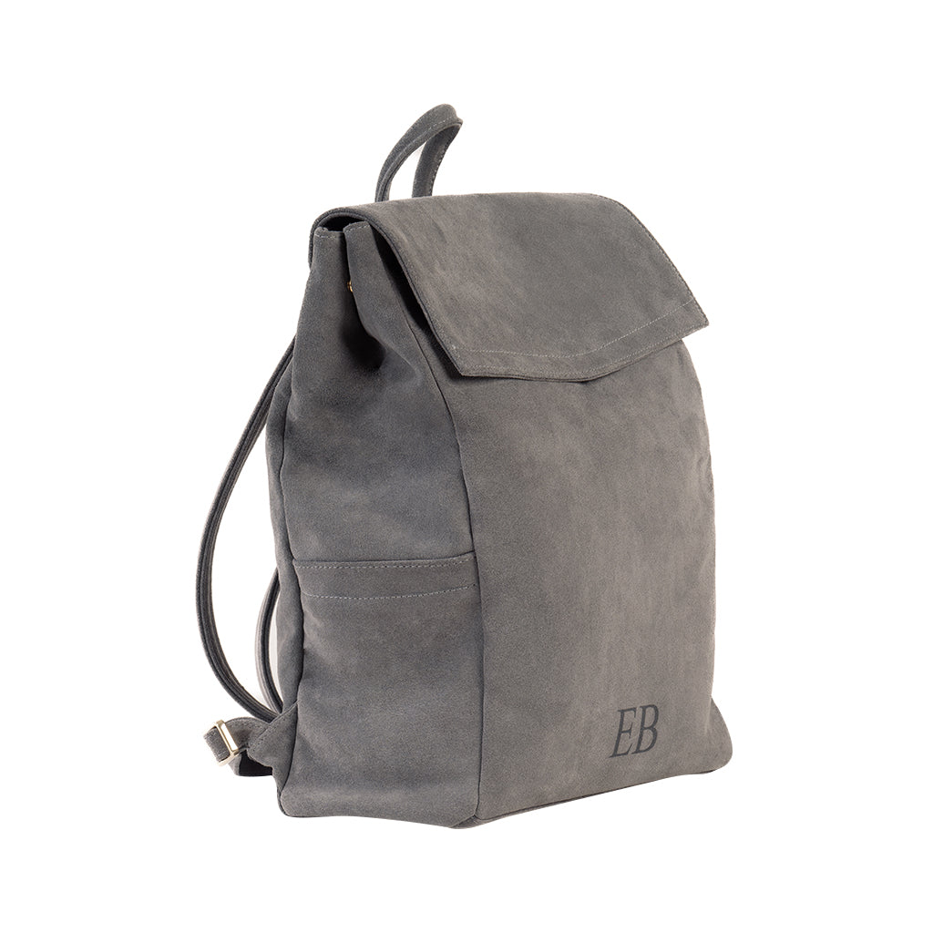 Sleek gray suede backpack with initials embossed in the bottom corner