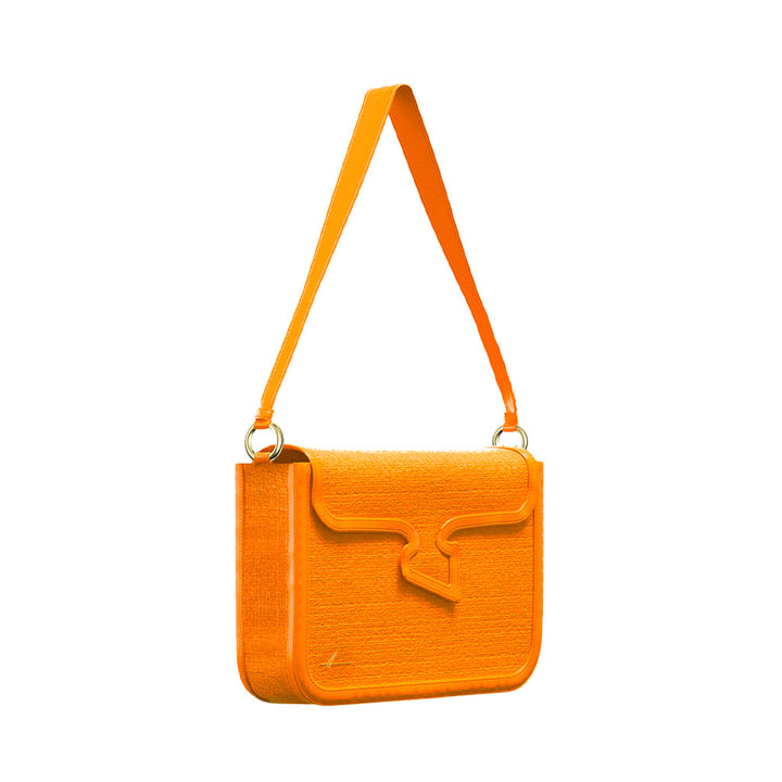 Orange shoulder bag with unique decorative flap and adjustable strap