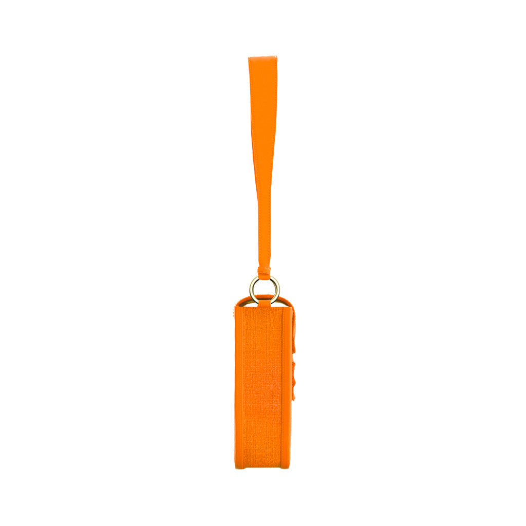 Bright orange wristlet side view with leather strap and gold ring detail
