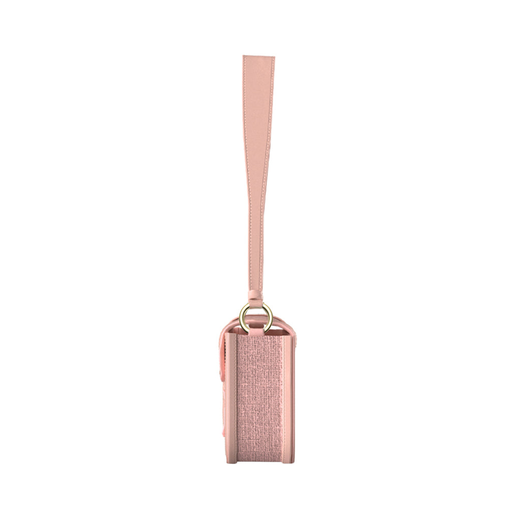 Pink leather crossbody bag with adjustable strap and gold hardware, side view