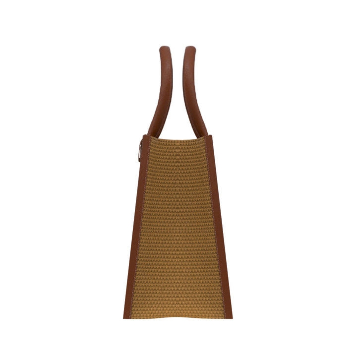 Side view of a stylish brown leather and woven straw handbag with dual handles