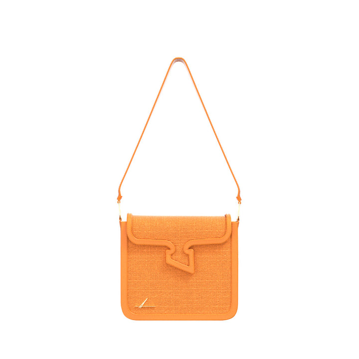 Orange shoulder bag with unique flap design and leather strap on white background