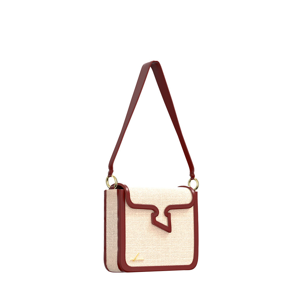 Beige and red leather crossbody handbag with textured finish and gold accents