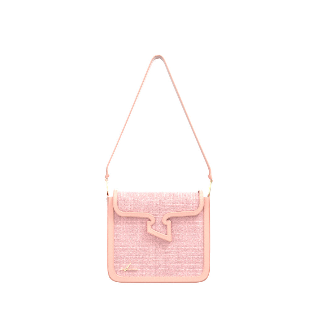 Pink crossbody handbag with textured surface and unique flap design