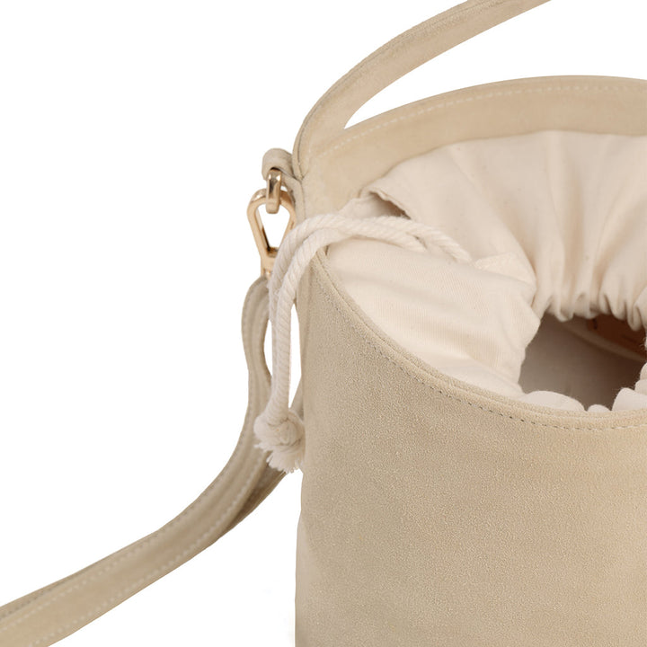 Beige suede bucket bag with drawstring closure and detachable strap