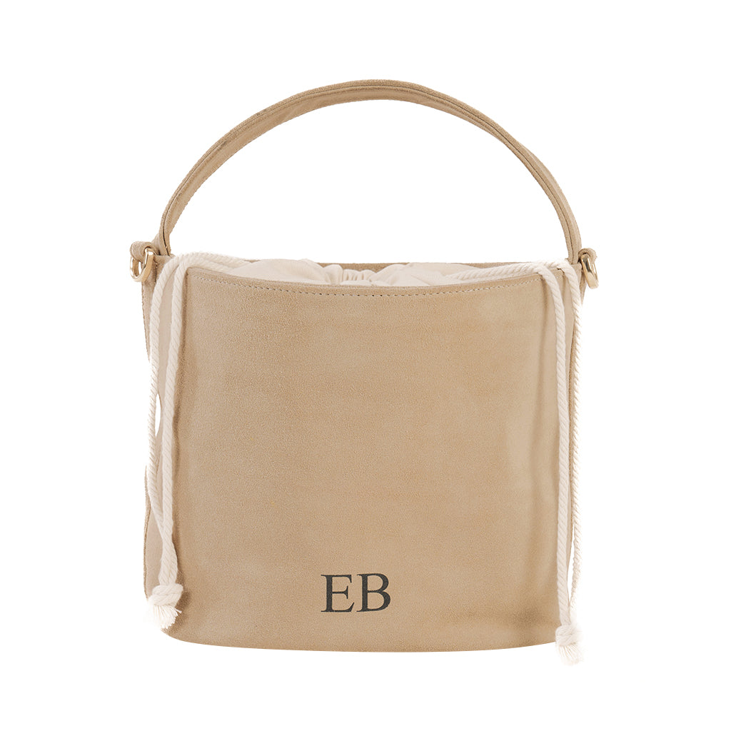 Tan suede bucket bag with initials EB and drawstring closure