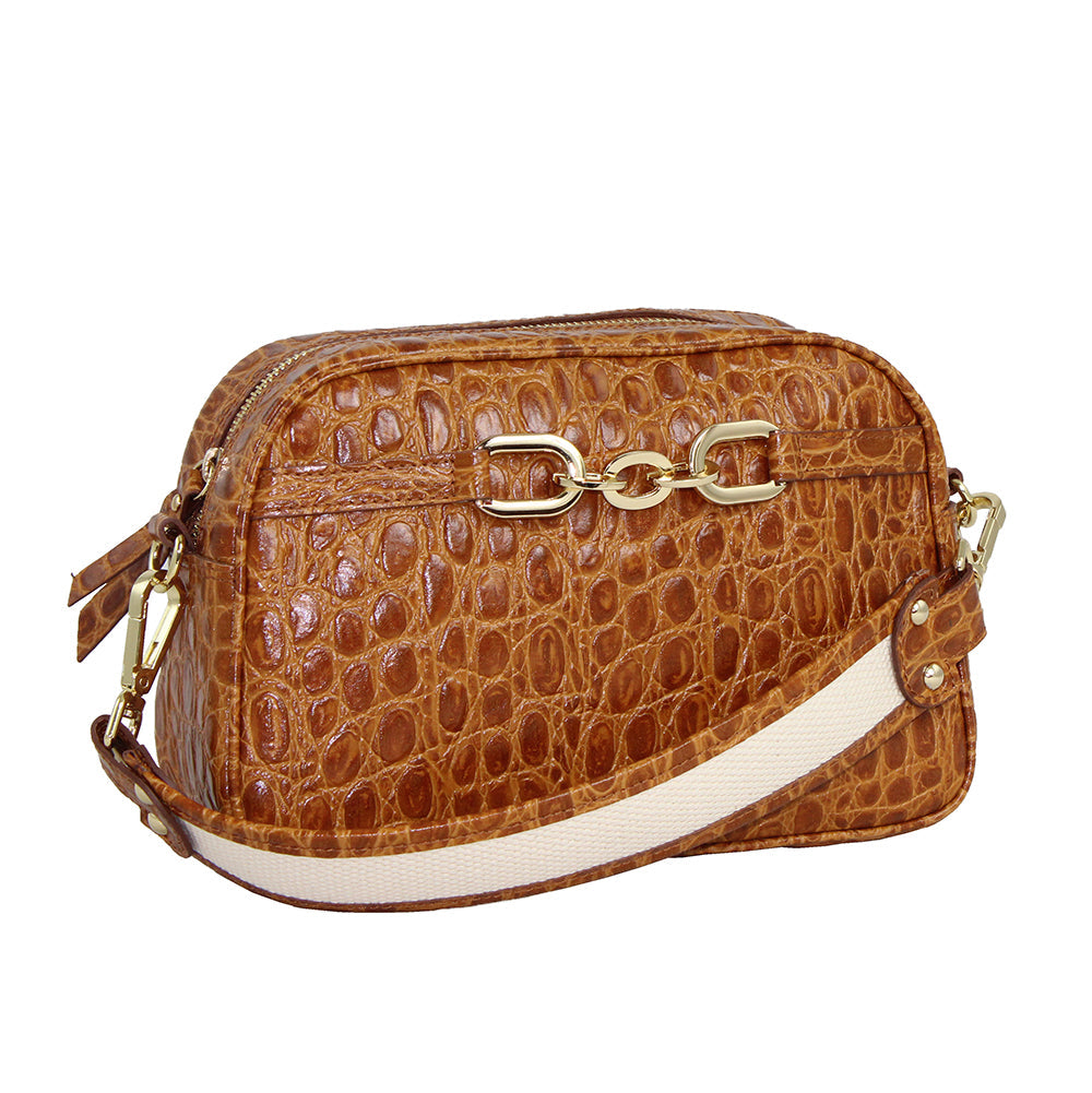Brown crocodile pattern leather handbag with gold chain links and adjustable white strap