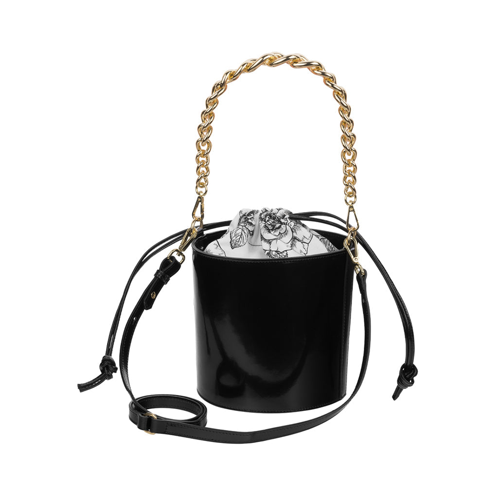 Black leather bucket bag with gold chain handle and floral interior lining