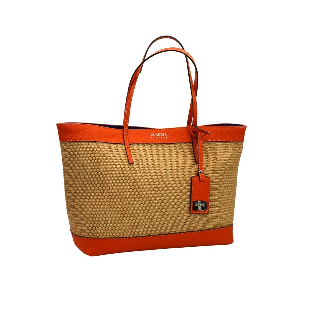 Orange and beige woven tote bag with leather handles and a small tag