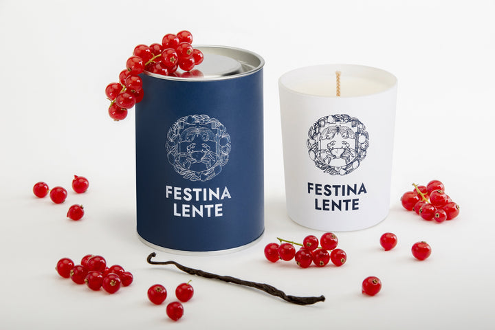Festina Lente candles with currants and vanilla beans on white background