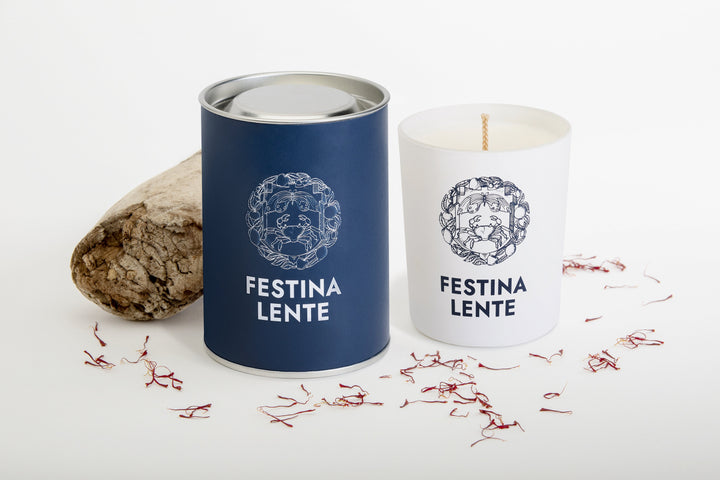 Festina Lente candle and packaging with nature-inspired design and decorative elements