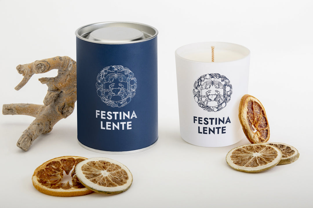 Luxury scented candle with decorative packaging and dried citrus slices