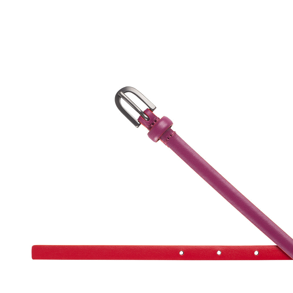 Red and pink leather belt with silver buckle on white background