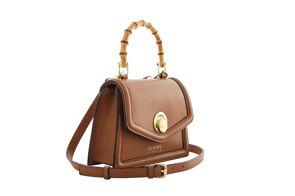 Luxury brown leather handbag with bamboo handle and gold buckle clasp
