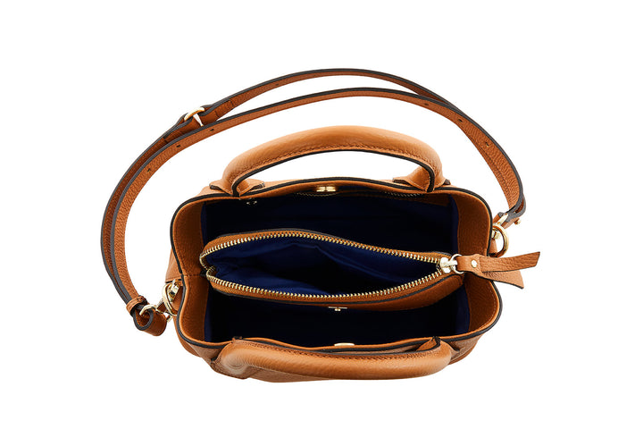 Brown leather handbag with navy blue interior and gold zippers