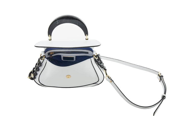 White and navy blue leather handbag with flexible strap and gold-tone hardware