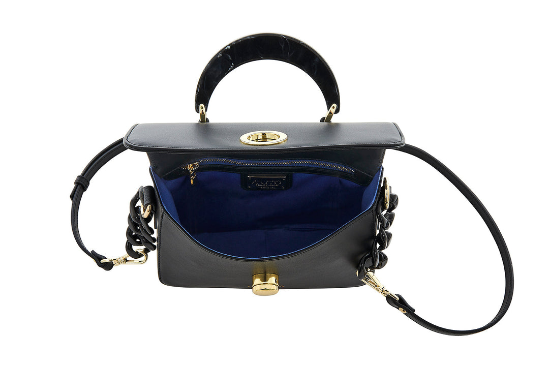 Black leather handbag with gold hardware, open to show blue interior lining and zippered pocket