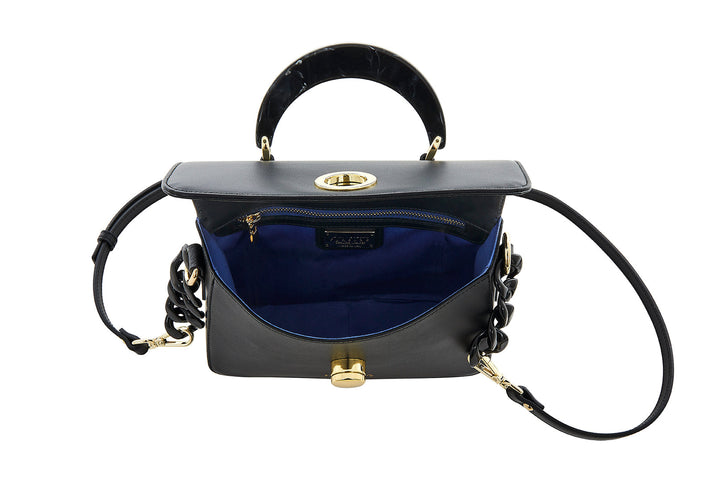 Black leather handbag with gold hardware, open to show blue interior lining and zippered pocket