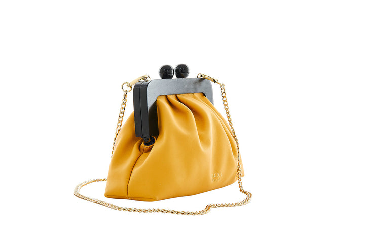 Yellow leather handbag with gold chain strap and black clasp