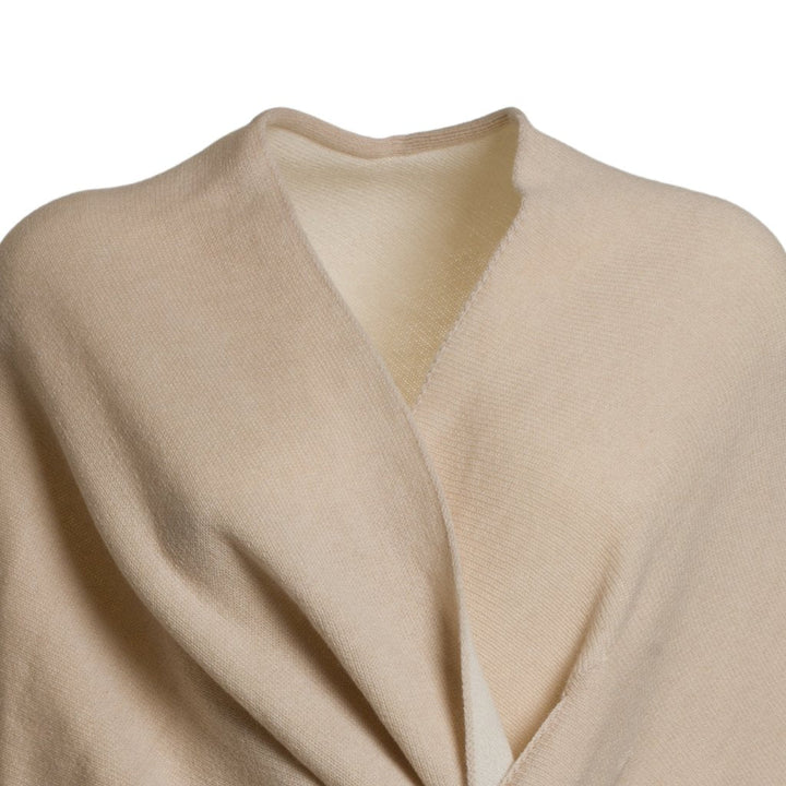 Beige woolen shawl wrapped around shoulders