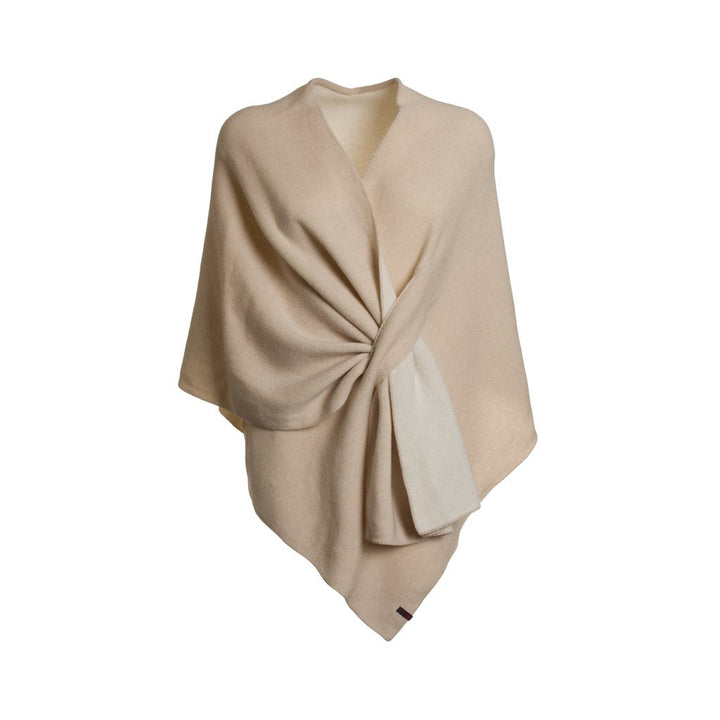 Beige wool poncho wrap folded elegantly against a white background