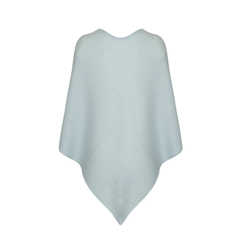 Light blue knitted poncho against white background