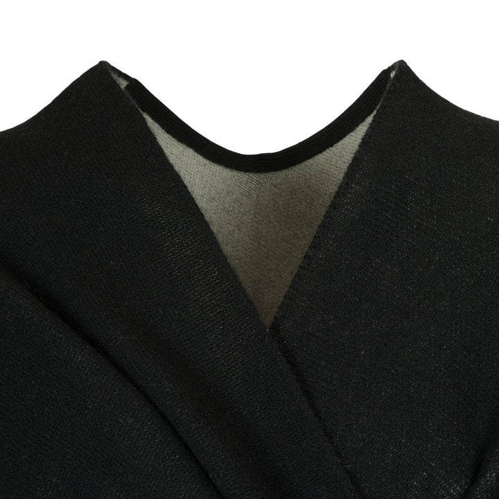 Close-up of a black wool shawl with a grey inner lining