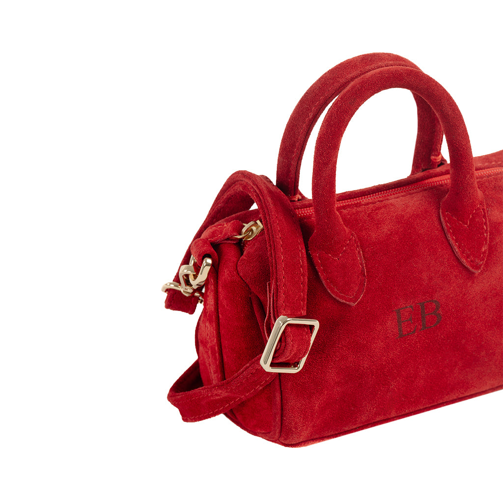 Red suede mini handbag with gold hardware and short handles