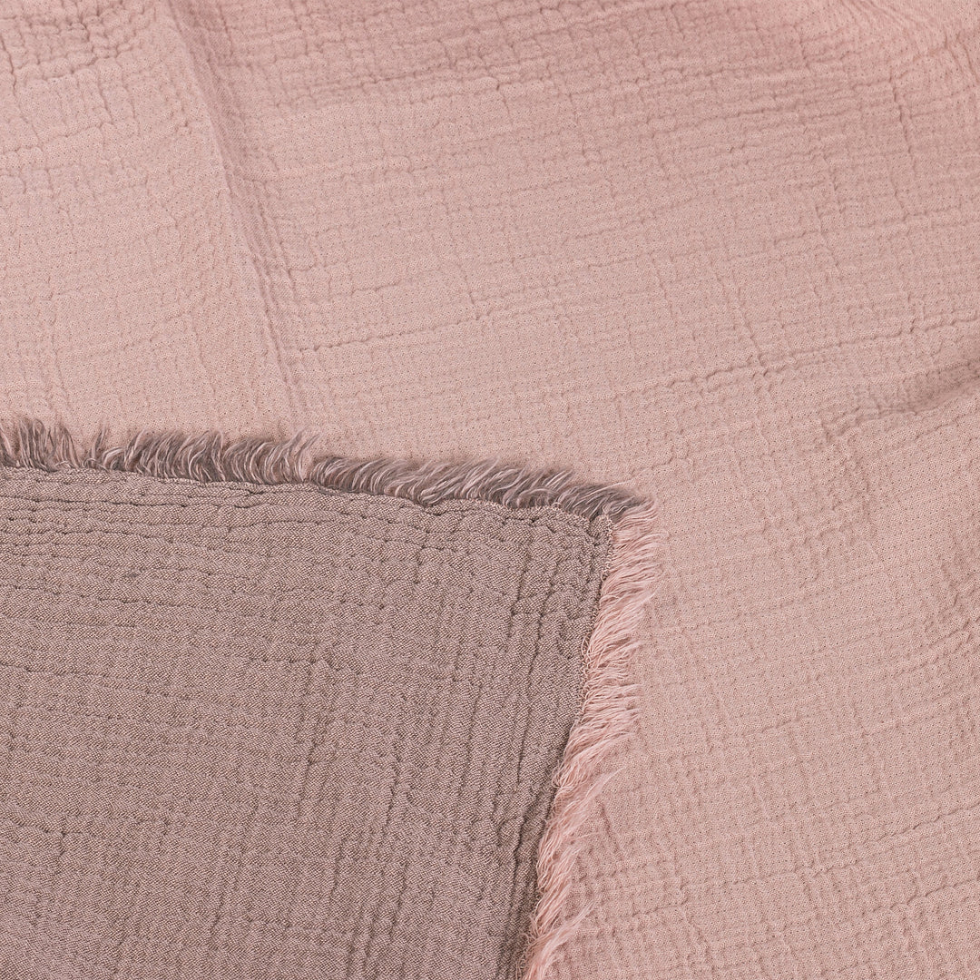 Soft pink textured fabric with fringed edges