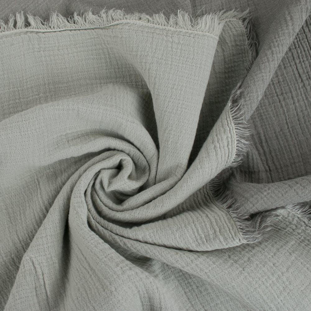 Close-up of soft gray textured fabric with frayed edges