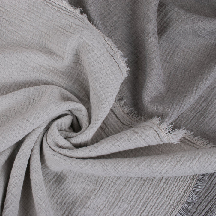 Close-up of soft, textured gray fabric with frayed edges