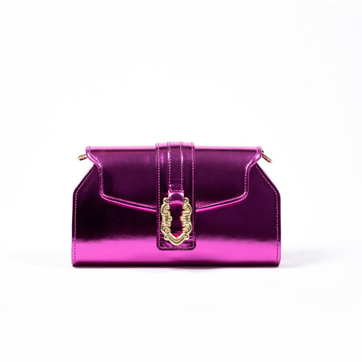 Shiny pink clutch bag with gold buckle detail against white background