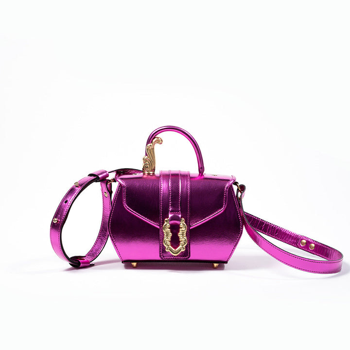 Shiny metallic pink handbag with gold accents and adjustable shoulder strap