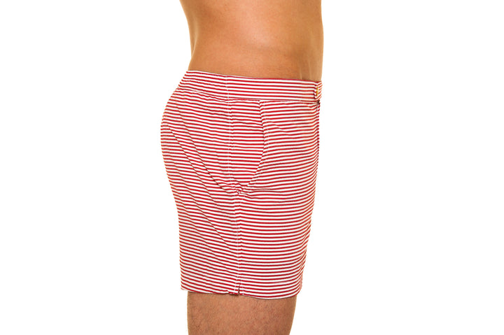 Side view of a person wearing red and white striped shorts on a white background