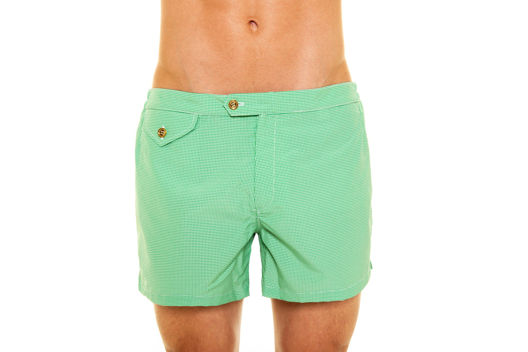 Close-up of a person wearing green striped swim trunks