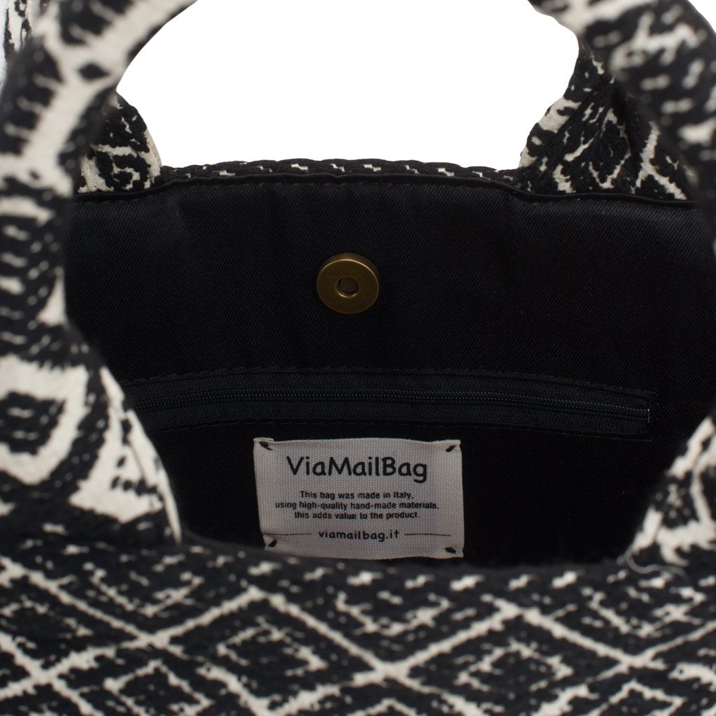 Black and white patterned handbag with ViaMailBag label and interior pocket