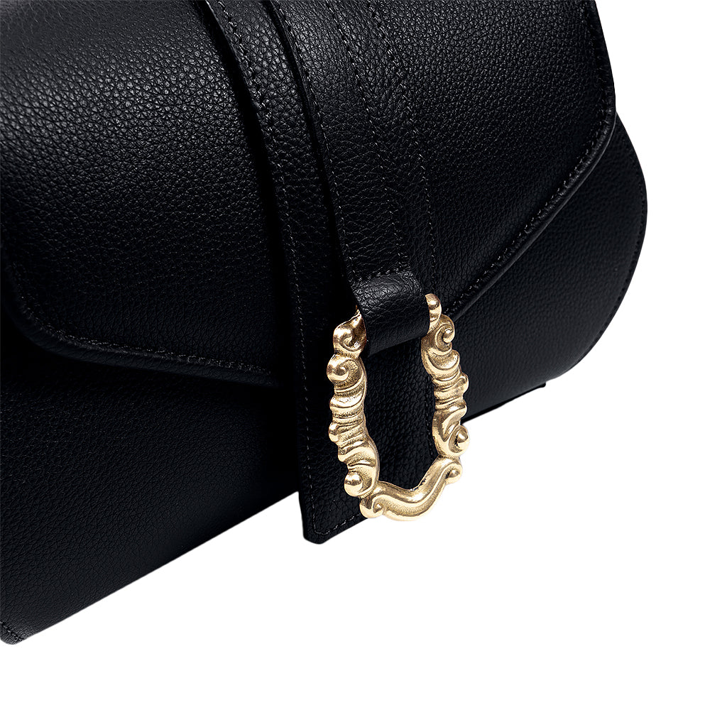 Black leather handbag with a gold decorative buckle