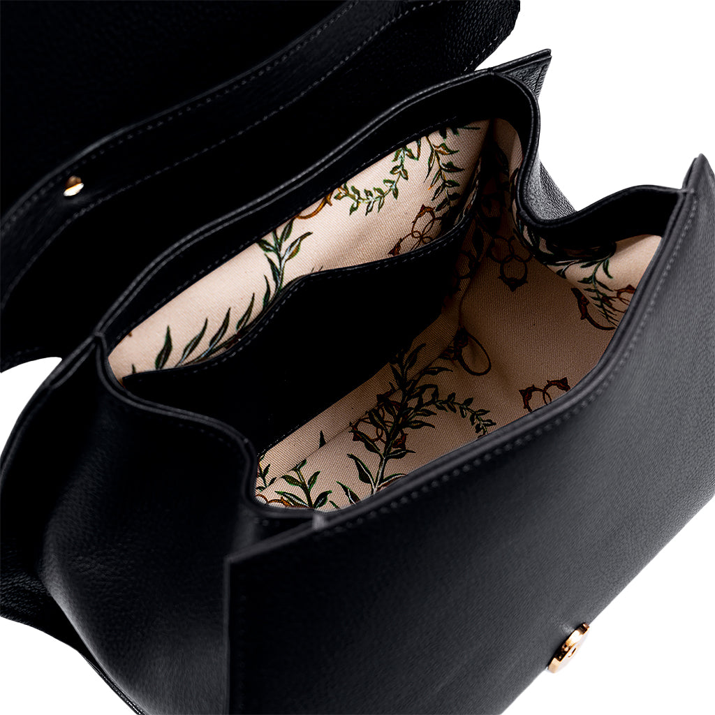 Open black leather handbag with floral-patterned interior lining