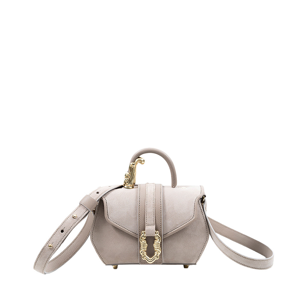 Elegant beige leather handbag with gold-tone hardware and shoulder strap