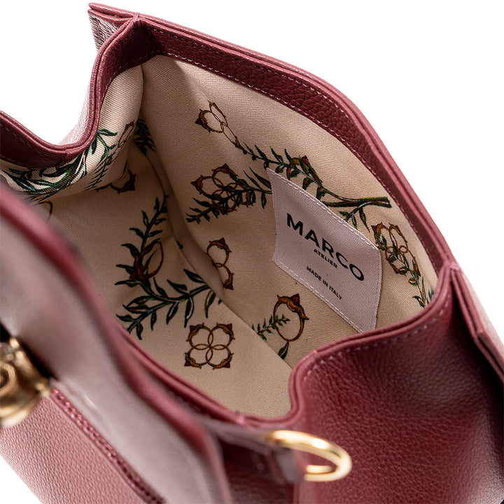 Close-up of a maroon leather handbag interior with floral fabric lining and MARCO label