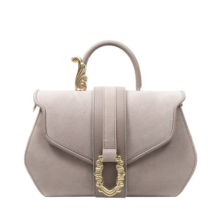 Elegant beige leather handbag with gold ornate clasp and handle detail