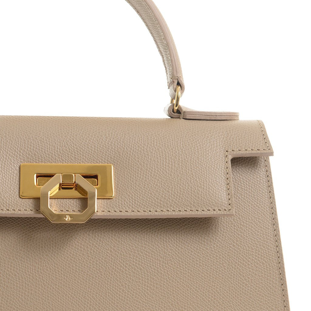 Beige leather handbag with gold hardware and top handle