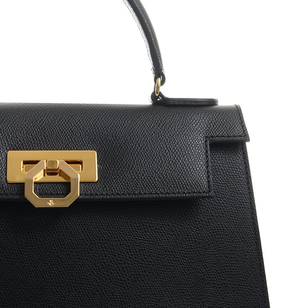 Elegant black leather handbag with gold buckle detail