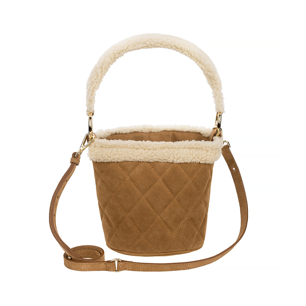 Tan quilted bucket bag with faux fur trim and adjustable strap on a white background
