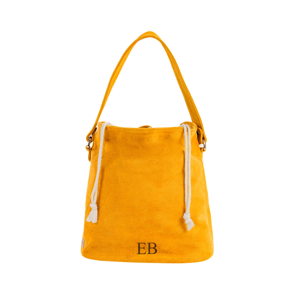 Yellow suede bucket bag with drawstring closure and initials EB on front