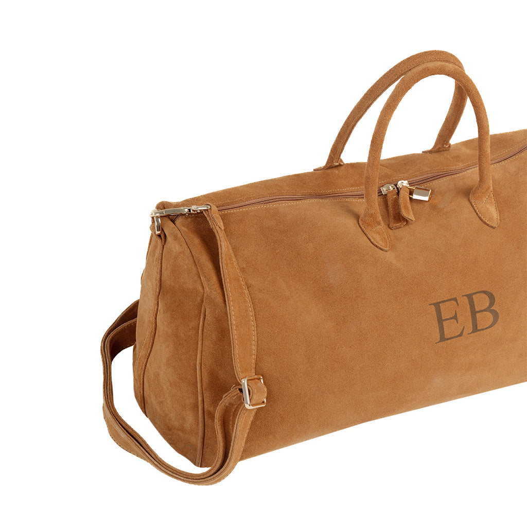 Brown suede duffle bag with monogram initials â€œEBâ€ and shoulder strap